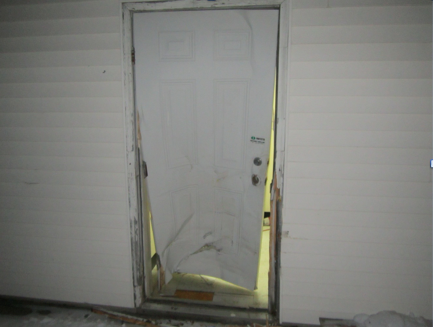 The rear door of the Mt. Blue Drug Store in Farmington shows damage allegedly caused by a man repeatedly ramming it with a pickup truck. Courtesy Farmington Police Department