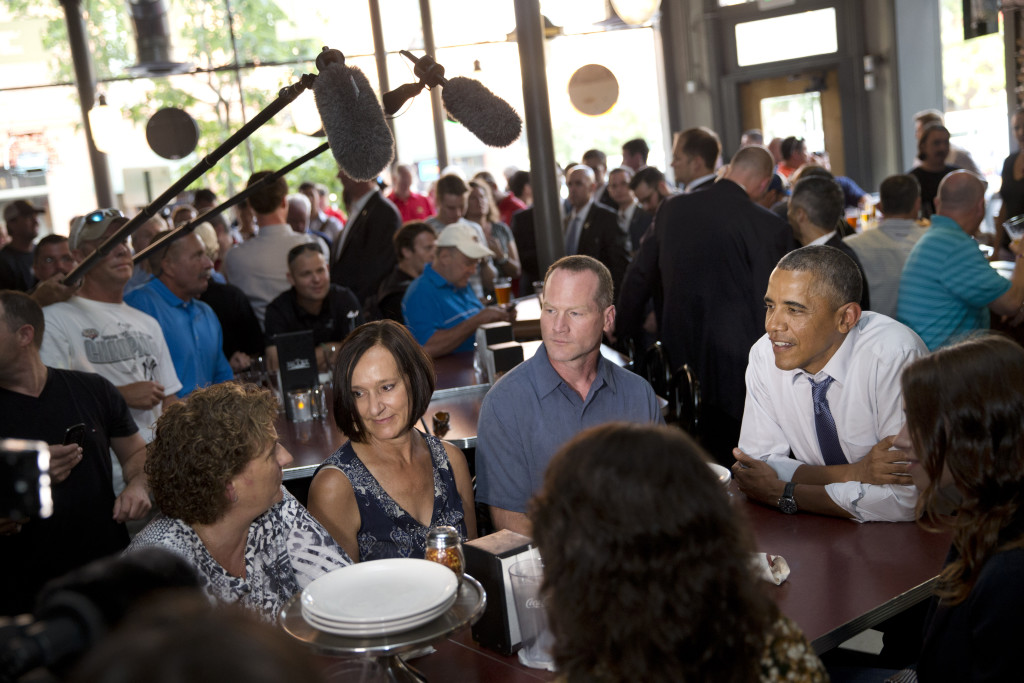 Leslie Gresham, left, Carolyn Reed and David Johnson, all of whom wrote President Barack Obama letters, have dinner with the President in Denver on July 8, 2014. Reed is a guest to watch President Barack Obama's State of the Union address on Capitol Hill Tuesday. The Associated Press