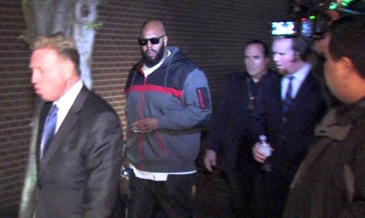 An image from video of Death Row Records founder Marion "Suge" Knight, right, walking into the Los Angeles County Sheriff's Department early Friday morning in connection with a hit-and-run incident that left one man dead and another injured. The Associated Press / OnSceneVideo