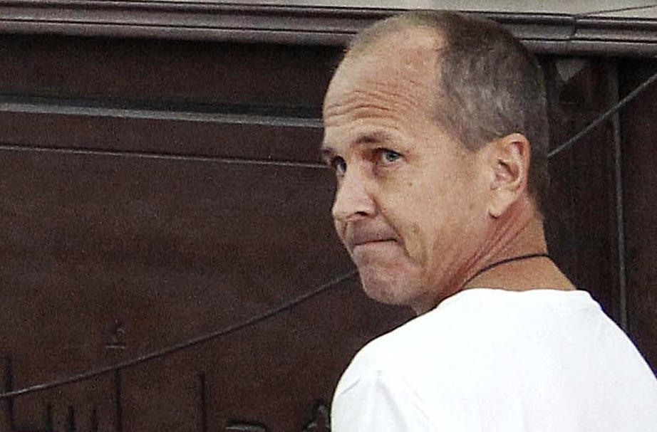 In this Monday 2014 photo, Al-Jazeera English correspondent Peter Greste, appears in court along with several other defendants during their trial on terror charges, in Cairo, Egypt. Greste was freed from prison on Sunday.