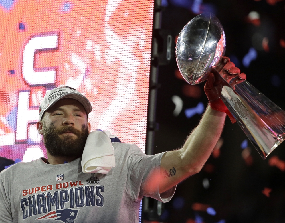 New England Patriots wide receiver Julian Edelman holds up the Vince Lombardi Trophy after the Patriots beat the Seattle Seahawks in the Super Bowl on Sunday in Glendale, Ariz.