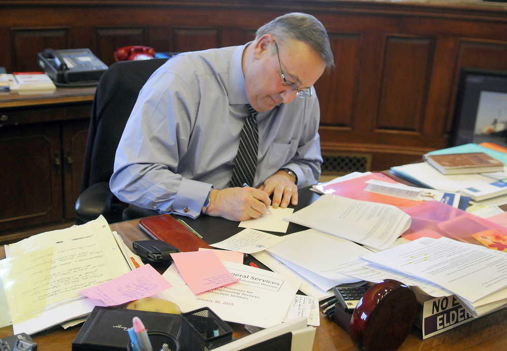 Gov. Paul LePage makes a note Monday while drafting his State of the State speech that he will present before a joint session of the Legislature tonight. LePage said he plans to outline a transformation of the state tax code during the speech that he wrote in his office in Augusta.