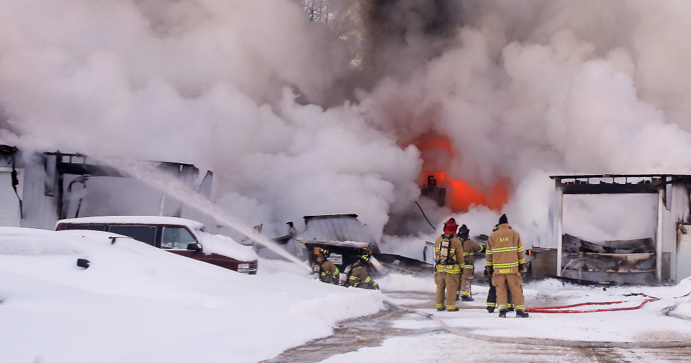 Kennebunk firefighters respond to a Route 1 fire Tuesday that destroyed a building that housed an auto repair shop and a kitchen design business.