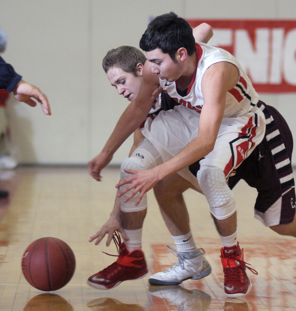 Cony’s Tyler Tardiff, right, collects a loose ball from Edward Little High School’s Luke Sterling during a Kennebec Valley athletic Conference Class A game Tuesday  in Augusta.