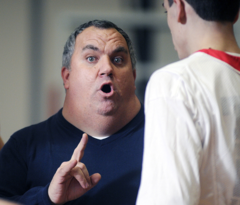 Staff photo by Andy Molloy 
 Cony boys basketball coach T.J. Maines addresses his team in an Edward Little timeout during a KVAC A game Tuesday in Augusta.