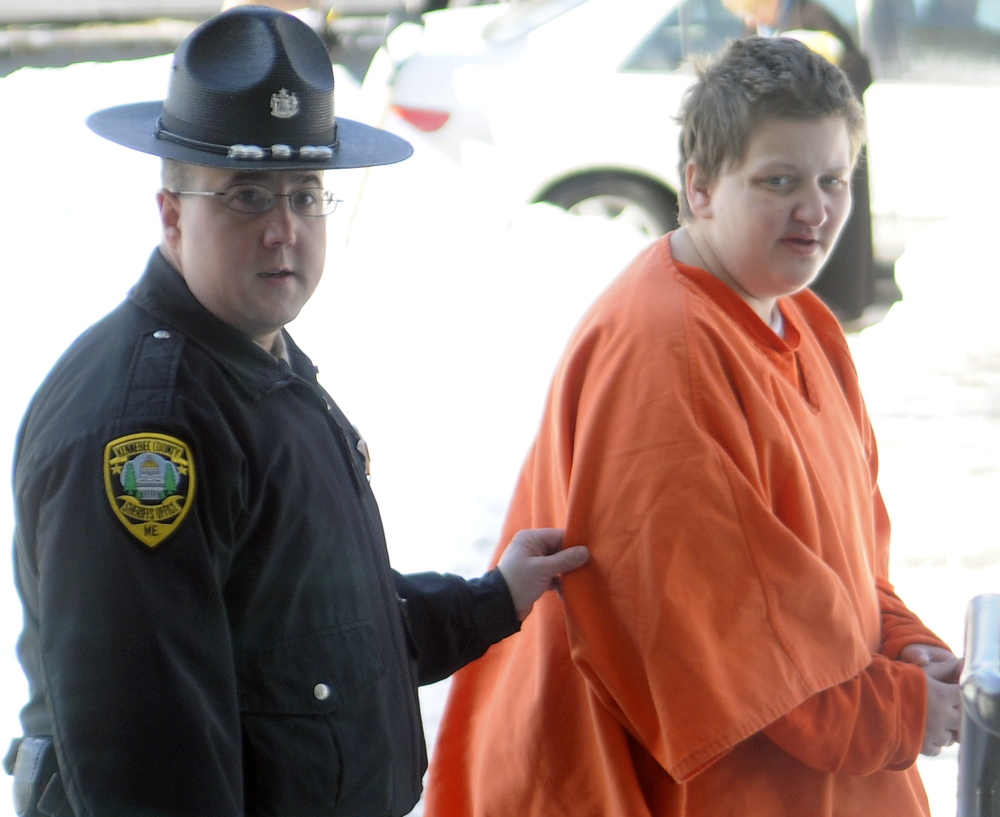 Arlene M. Edson is escorted Wednesday into Kennebec County Superior Court in Augusta. Edson was sentenced to jail after pleading guilty to assaulting staff at Riverview Psychiatric Center, where she has been a patient.