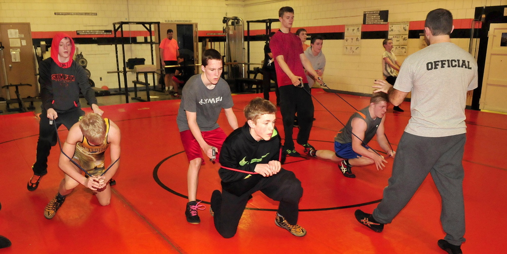 Skowhegan Area High School wrestling coach Brooks Thompson coaches members of the team during practice on Tuesday.