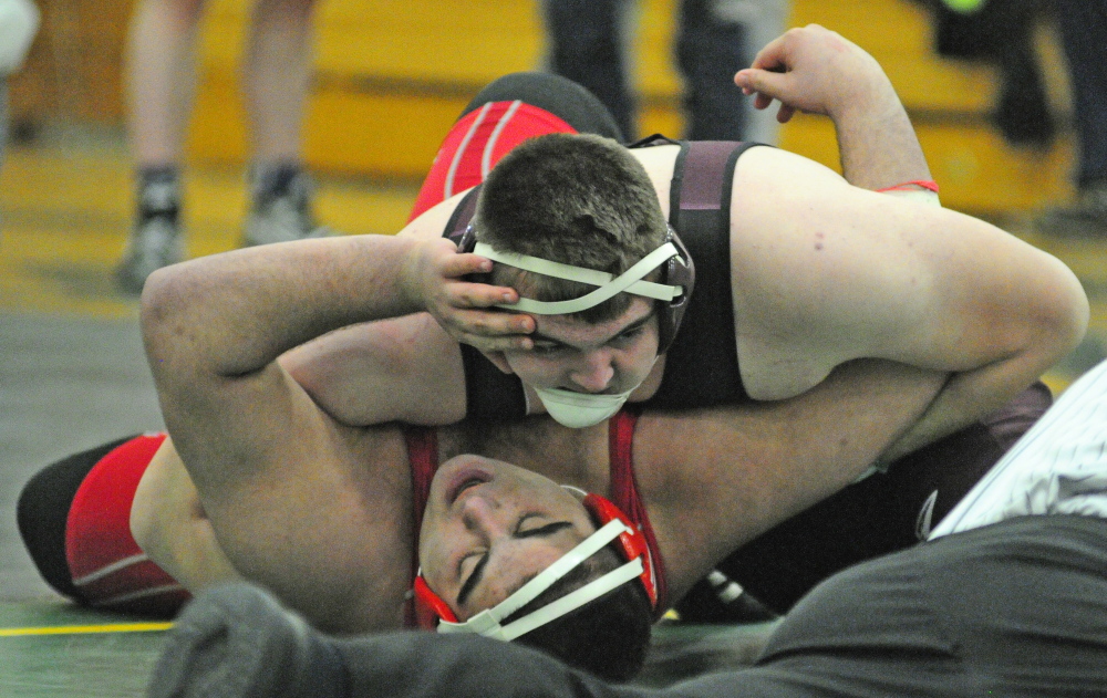 Nokomis’ Jacob Nichols, top, pins Cony’s Elias Younes in the 285-pound finals during the Eastern A wrestling championships Saturday at Oxford Hills.