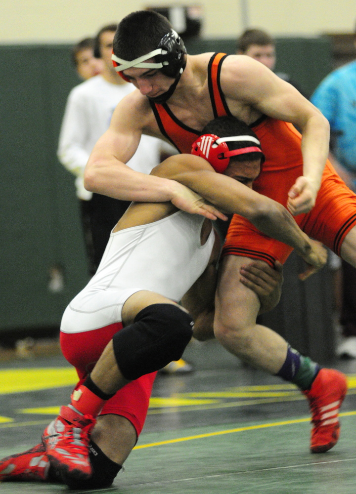 Cony’s Zeko Caudill, bottom, and Skowhegan’s Julian Sirois compete in the 138-pound finals during the Eastern A championships Saturday at Oxford Hills. Caudill won by a pin.