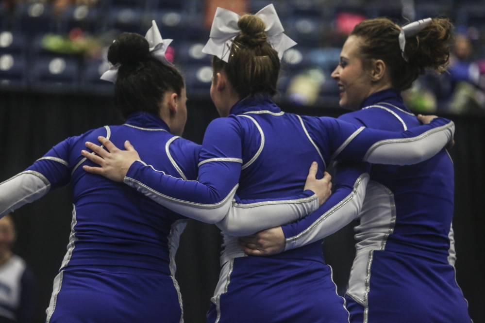 Maine Sunday Telegram photo by by Whitney Hayward 
 Lawrence high school teammates embrace after their performance at the Class A cheerleading championships Saturday at the Augusta Civic Center.