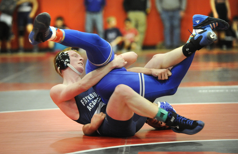 Maine Sunday Telegram photo by John Ewing 
 Fryeburg Academy's Patrick Duffy battles Erskine's Justin Studholme during a 138-pound match at the Western B championships Saturday at Wells. Studholme advanced with a win.
