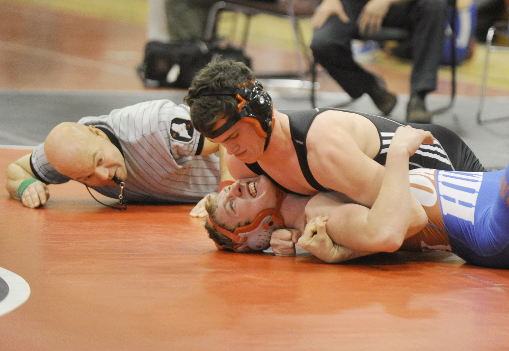 Maine Sunday Telegram photo by John Ewing 
 Referee Josh Stone watches closely as York's Connor Elsmore works to pin Oak Hill's Brendon Tervo in a 170-pound match Saturday at the Western B championships.