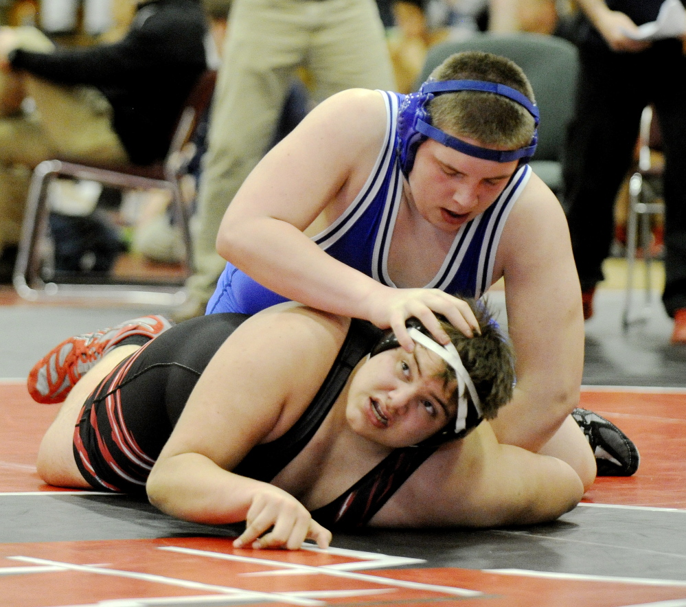 Maine Sunday Telegram photo by John Ewing 
 Erskine's Jake Peavey pushes down on the head of Wells' Matt Healy during their 285-pound match Saturday at the Western B championships in Wells.