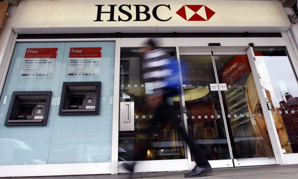 In this Feb. 27, 2012 file photo, a pedestrian passes a branch of HSBC bank in London. The chair of parliaments Public Accounts Committee says the former chief of HSBC must face serious questions after once-secret papers outlined how the bank helped the wealthy dodge taxes.