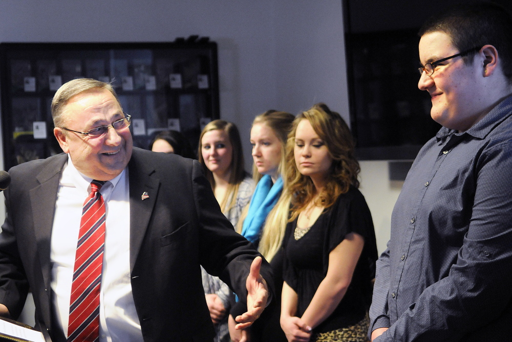Gov. Paul LePage acknowledges Jobs for Maine’s Graduates students and others during an announcement Tuesday at the State House of a $200,000 grant from AT&T to expand the program to Augusta’s Cony High School.