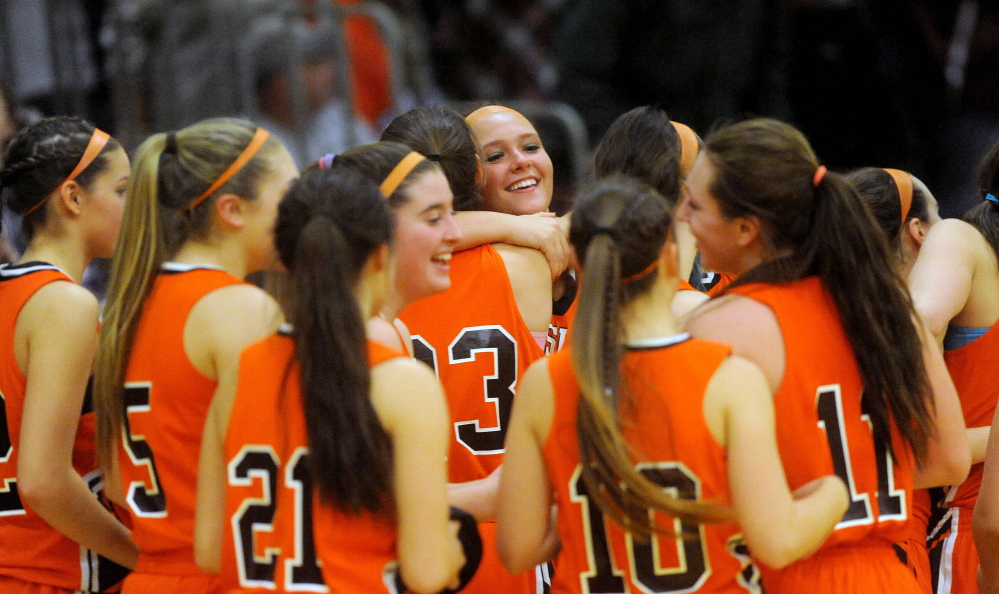Members of the Winslow High School girls basketball team celebrate their 34-29 win over Nokomis in an Eastern B prelim game Tuesday in Newport. Winslow will play No. 2 Presque Isle in a regional quarterfinal game Friday at 6:30 in Bangor.