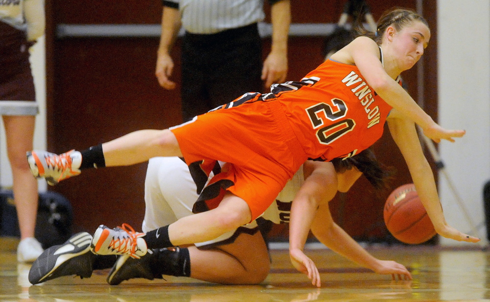 Winslow’s Ciara LeClair, front, dives for the loose ball with Nokomis’ Mikayla Charters in an Eastern B prelim game Tuesday night. Winslow will play No. 2 Presque Isle in a regional quarterfinal game Friday at 6:30 in Bangor.