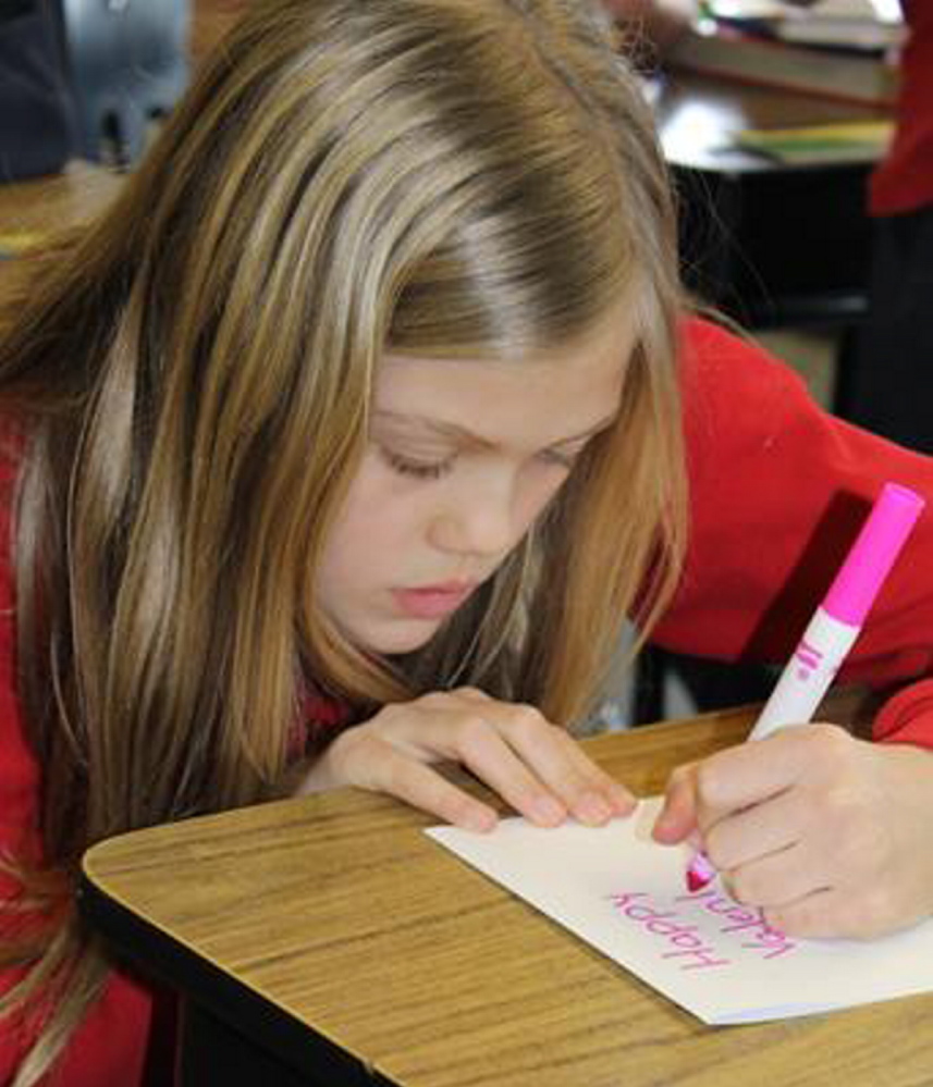 Contributed photo 
 Haleigh McLain, a fifth-grade student at St. Michael School in Augusta, works on a Valentine's Day card.