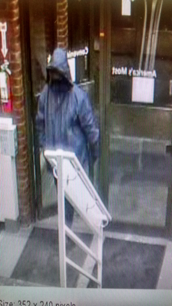 Security camera photograph of the man police say robbed the TD Bank on Main Street in downtown Waterville on Thursday.  The man wore a black cap and full face mask, and is described as being about 6 feet tall and weighing about 250 pounds.