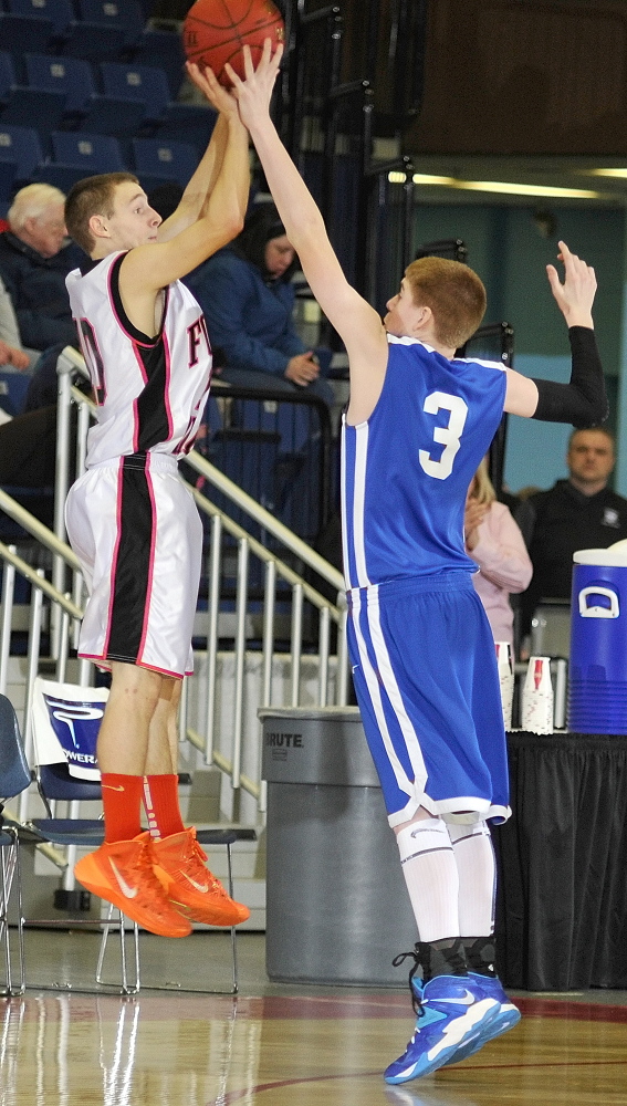 Forest Hills guard Brandon Ouellette, left, tries to shoot over Valley guard Cody Lawyerson during a Western D semifinal game last season in Augusta. The two teams are back in the hunt this season.