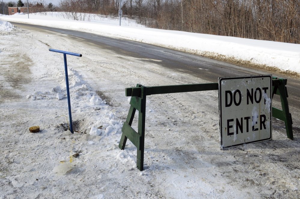 A barricade blocks Garden Lane in Hallowell on Feb. 7 while a wrench behind the barricade sticks out of a natural gas line shutoff valve. Garden Lane, a side street off Winthrop Street, is the driveway to Hall-Dale Elementary in Hallowell.