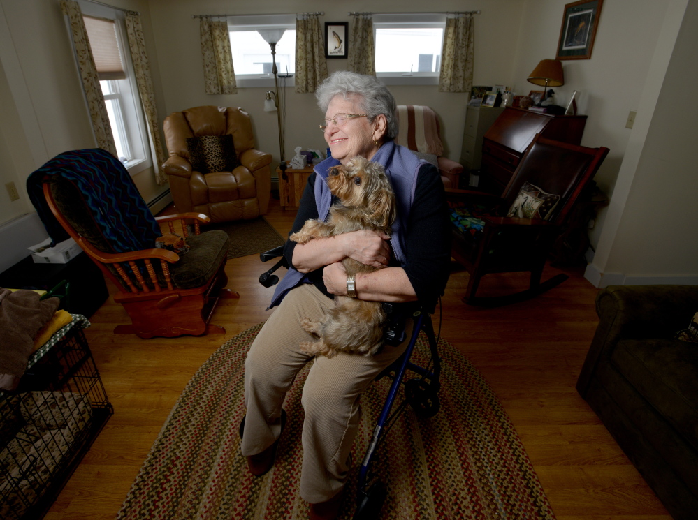 Dot Titicomb pwith her dog Molly at her home in Chesterville on Thursday. Titcomb is visited weekly as part of the Franklin County Sheriff’s Departmentn Elder Check program.