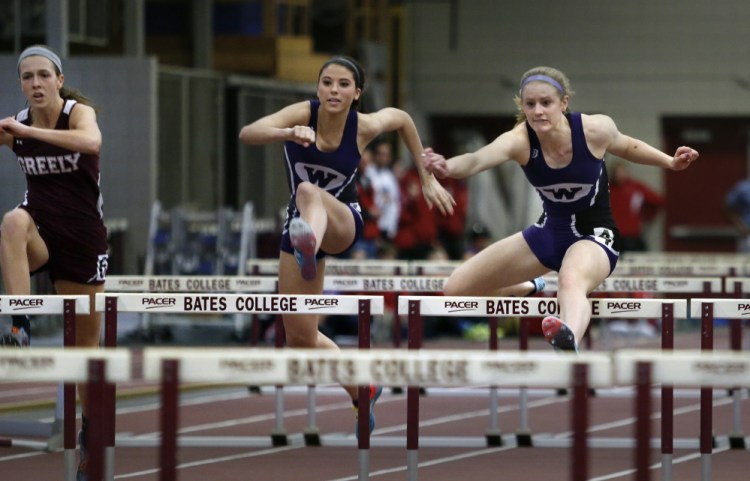 Sarah Shoulta of Waterville races ahead of teammate Kellie Bolduc and Jocelyn Mitiguy of Greely while competing in the 55 meter hurdles final Monday during the Class B indoor track and field championship meet.