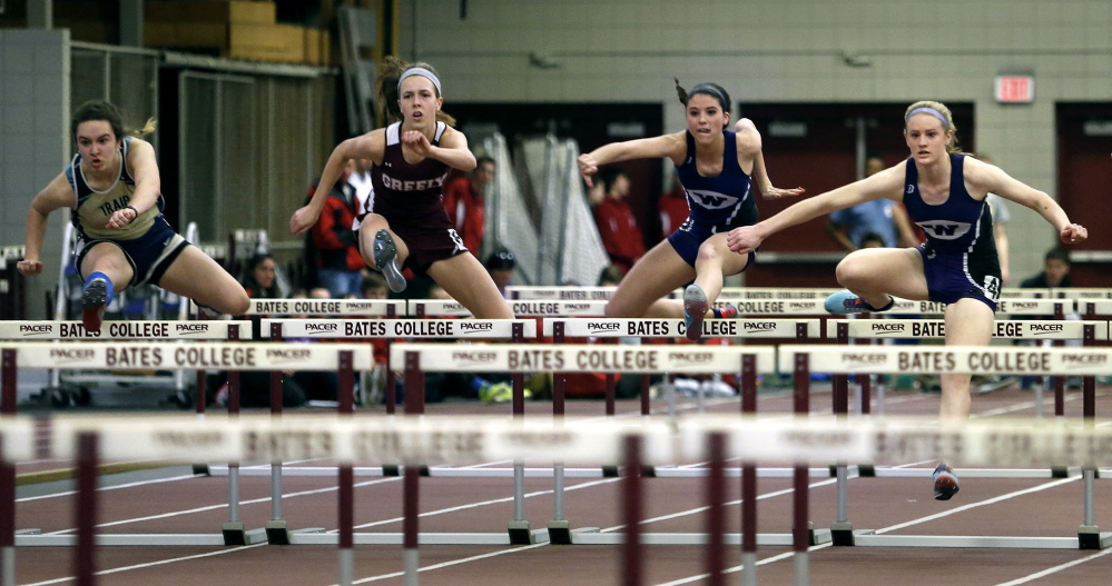 From left to right, Hannah Nightingale of Traip, Jocelyn Mitiguy of Greely, Kellie Bolduc of Waterville and Sara Shoulta of Waterville compete in the 55 meter hurdles final Monday during the Class B indoor track and field championship meet.