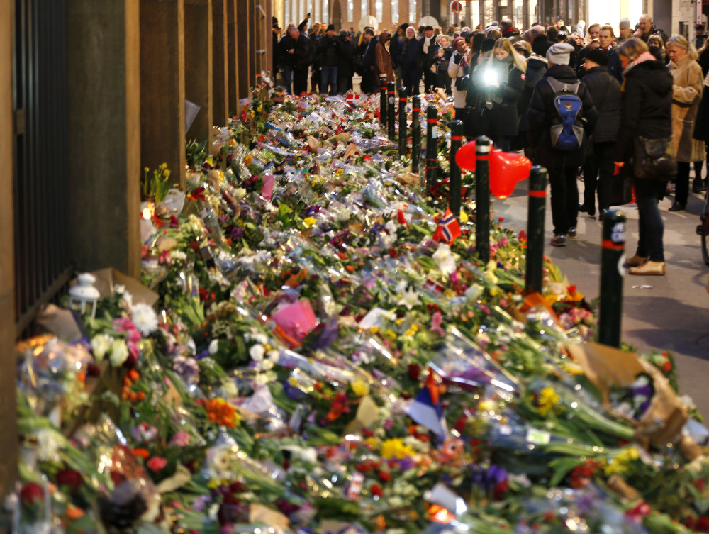 Flowers are laid in front of the synagogue in Copenhagen, Denmark, Tuesday, Feb. 17, 2015.