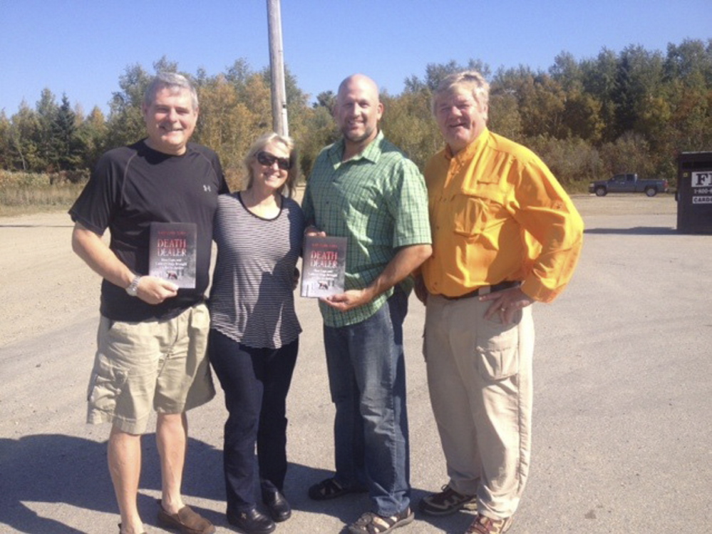 Kate Flora, second from left, poses with “Death Dealer” and, from left, Miramichi, N.B., Police Chief Paul Fiander, Deputy Chief Brian Cummings and Detective/Constable Dewey Gillespie. Flora’s book details how the department and Maine Search and Rescue Dogs worked together to solve a murder.