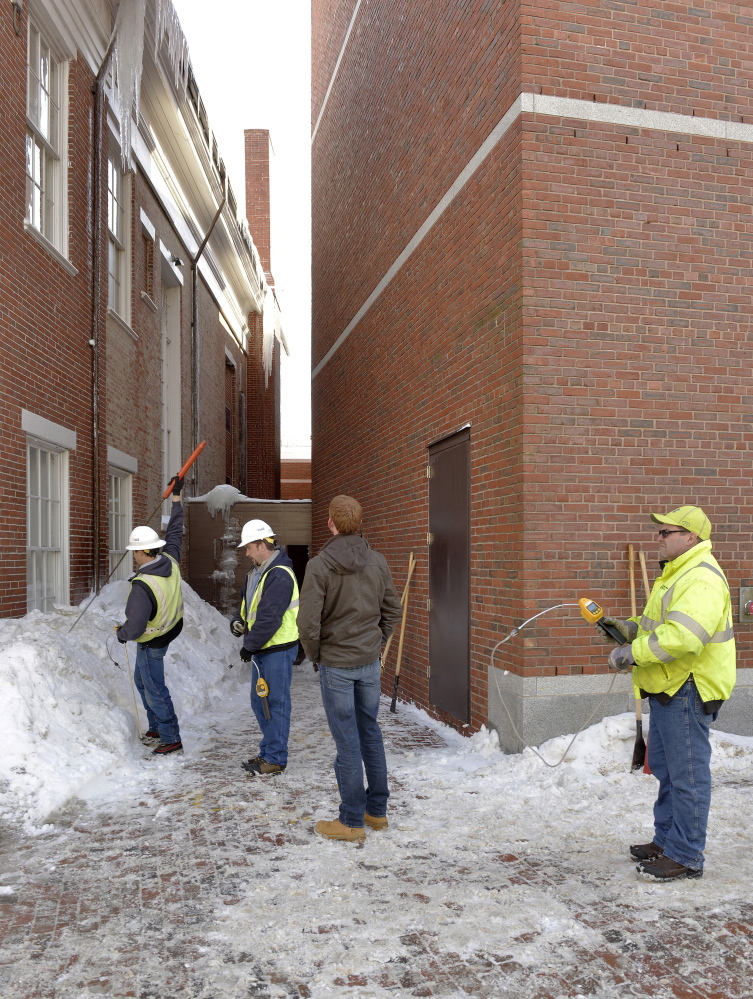 Unitil Gas Company crews check for gas fumes in the area near the Portland Museum of Art. A large icicle fell from the roof of the Children’s Museum and Theatre of Maine and punctured a gas line into the art museum.