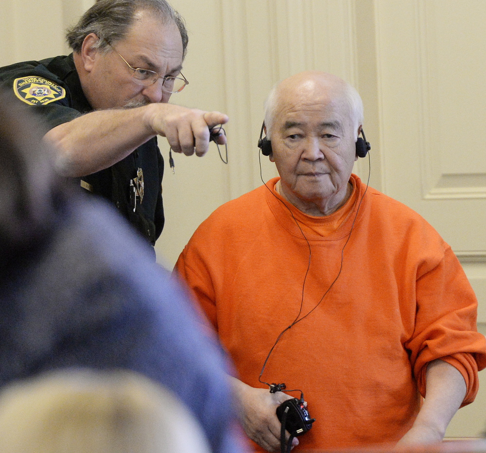 James Pak is directed to his seat in York County Superior Court in Alfred on Thursday. Pak has entered a plea of not guilty by reason of insanity on two counts of murder in the deaths of Derrick Thompson, 19, and Alivia Welch, 18.
