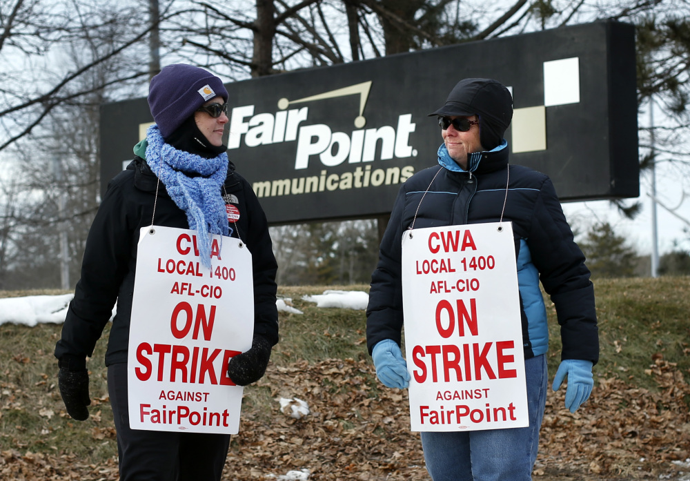 Fairpoint employees Amber Lyman, left, and Julie Sawtelle picket outside the company’s offices in Portland last month. The strike, which entered its 127th day Friday, is the longest in the telecommunications industry this century and involved about 1,700 workers in northern New England, including 800 in Maine.