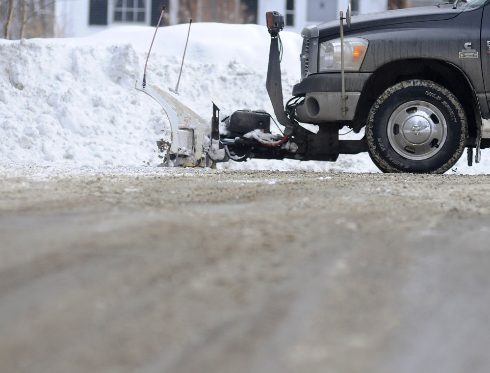 A private plow truck cleans up a road Thursday in Hallowell after removing snow from a driveway.