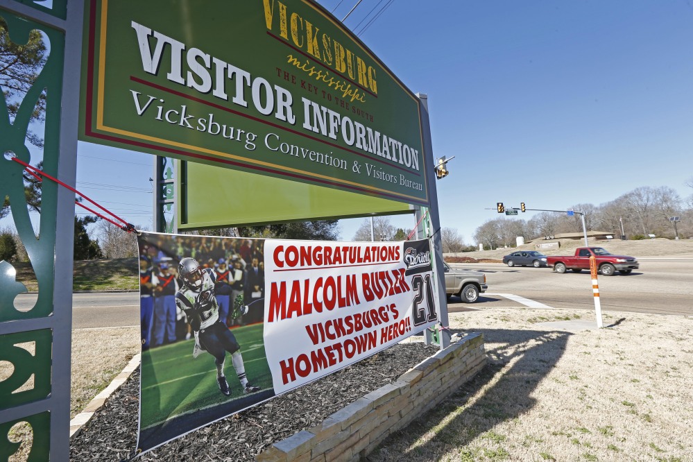 The sign for the city of Vicksburg, Miss., visitor’s center shares space with a newer sign touting Super Bowl hero and New England Patriots cornerback Malcolm Butler as a hometown hero. The city is holding a parade in Butler’s honor on Saturday.