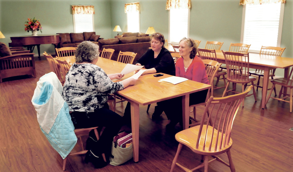 The New Hope Women’s Shelter has re-opened in an expanded facility in Solon. Having a meeting on Wednesday in the Common Room are, from left, staff members Christine Greenlaw, Director Rebecca Philpot and Gale Beaulieu.