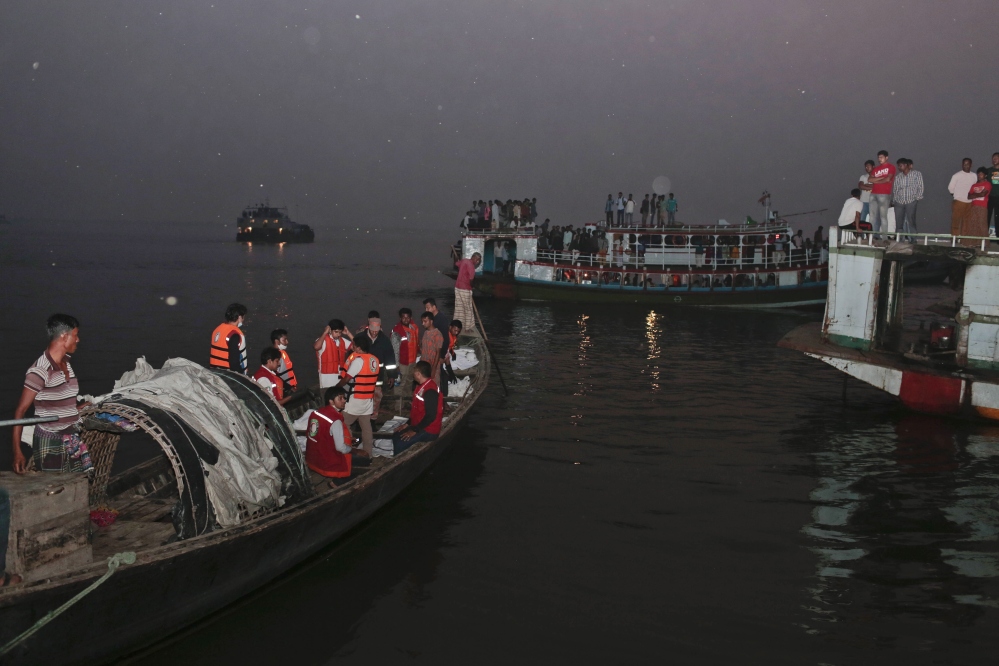 Bangladeshi rescue workers bring dead bodies of victims in a boat after a river ferry carrying about 100 passengers capsized Sunday after being hit by a cargo vessel,in Manikganj district, about 25 miles northwest of Dhaka, Bangladesh, on Sunday.