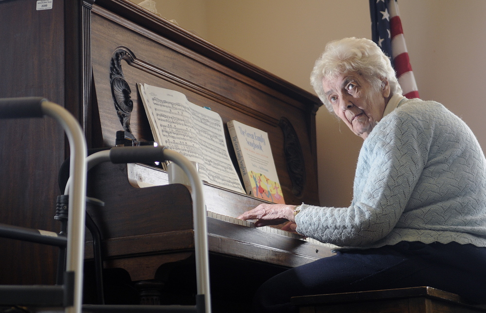 Joyce Fessenden, 83, plays the piano recently during lunch at the William S. Cohen Community Center in Hallowell. Fessenden uses a walker to reach the piano. She has been playing for 70 years to crowds large and small.