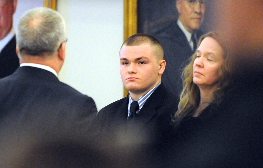 Kyle Dube, center, with his attorneys Stephen Smith, left, and Wendy Hatch is in court during the first day of Dube’s trial at the Penobscot Judicial Center in Bangor on Monday. Dube is charged with kidnapping and murder in the 2013 death of Nichole Cable, a high school sophomore from Glenburn.