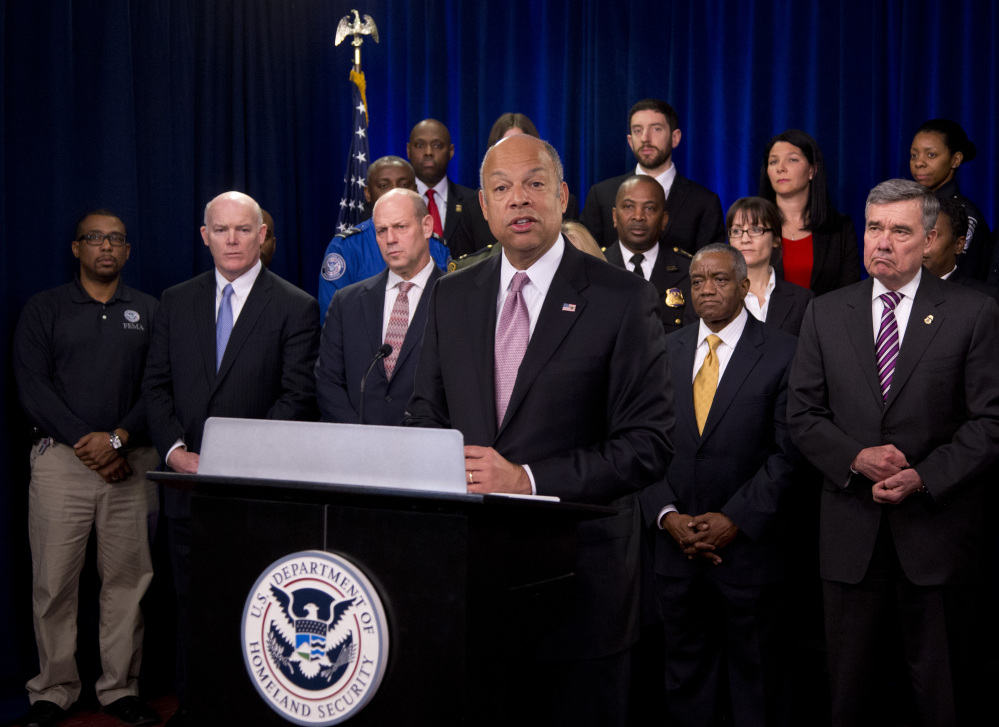 Homeland Security Secretary Jeh Johnson, joined by the department employees, speaks during a news conference in Washington on Monday to discuss the need for Congress to pass a full-year appropriations bill. Standing second from left is U.S. Secret Service Director Joseph Clancy, and U. S. Customs and Border Protection Commissioner Gil Kerlikowske is at right.