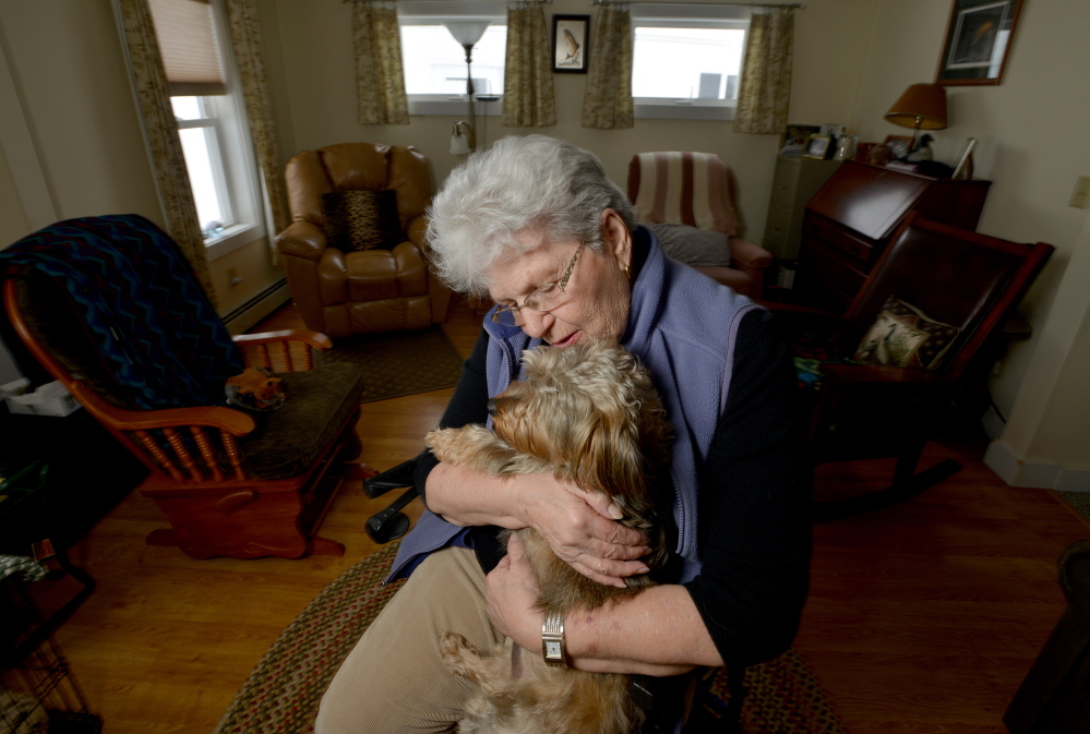 Dot Titcomb poses for a portrait with her dog, Molly, on Feb. 12 at her home in Chesterville. Titcomb receives weekly visits from local police to make sure she is safe. The visits are part of a program that resembles one being launched next week in Gardiner.