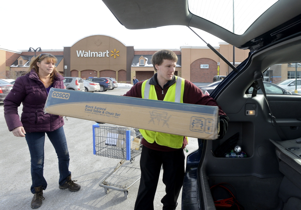 Customer Theresa Graham, from Windham, is assisted with a kitchen table set Tuesday by Walmart employee Thomas Bailey at the Walmart store in Scarborough.