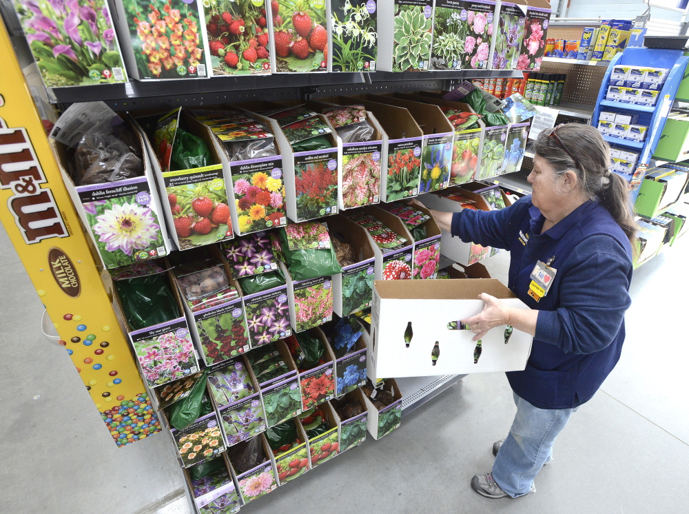 Walmart Lawn & Garden department manager Sue Mondor stocks shelves Tuesday at Walmart in Scarborough.