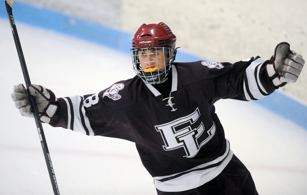 Staff photo by Michael G. Seamans 
 Edward Little High School's Max Giarard celebrates a goal during an Eastern A quarterfinal Tuesday night at Sukee Arena.