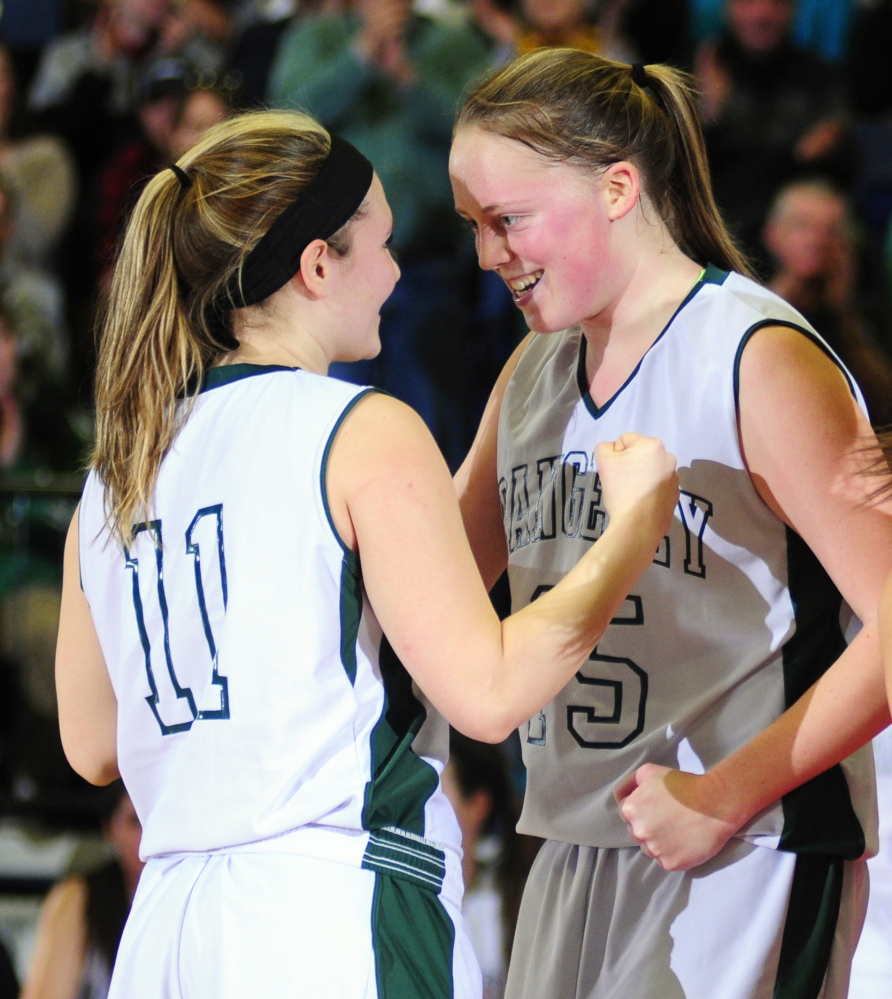 Rangeley’s Seve Deery-Raps, left, gets encouragement from teammate Taylor Esty before shooting another foul shot during the Western Maine Class D semifinal game earlier this month at the Augusta Civic Center. The Lakers will play Washburn for the Class D state title at 1:05 p.m., Saturday at the Cross Insurance Center in Bangor.