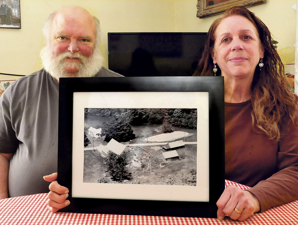 Rene and Janet Burdet hold a copy of an aerial photograph of their farm in Cornville taken in 1963. Their home is at upper left but most outbuildings have succumbed to age.