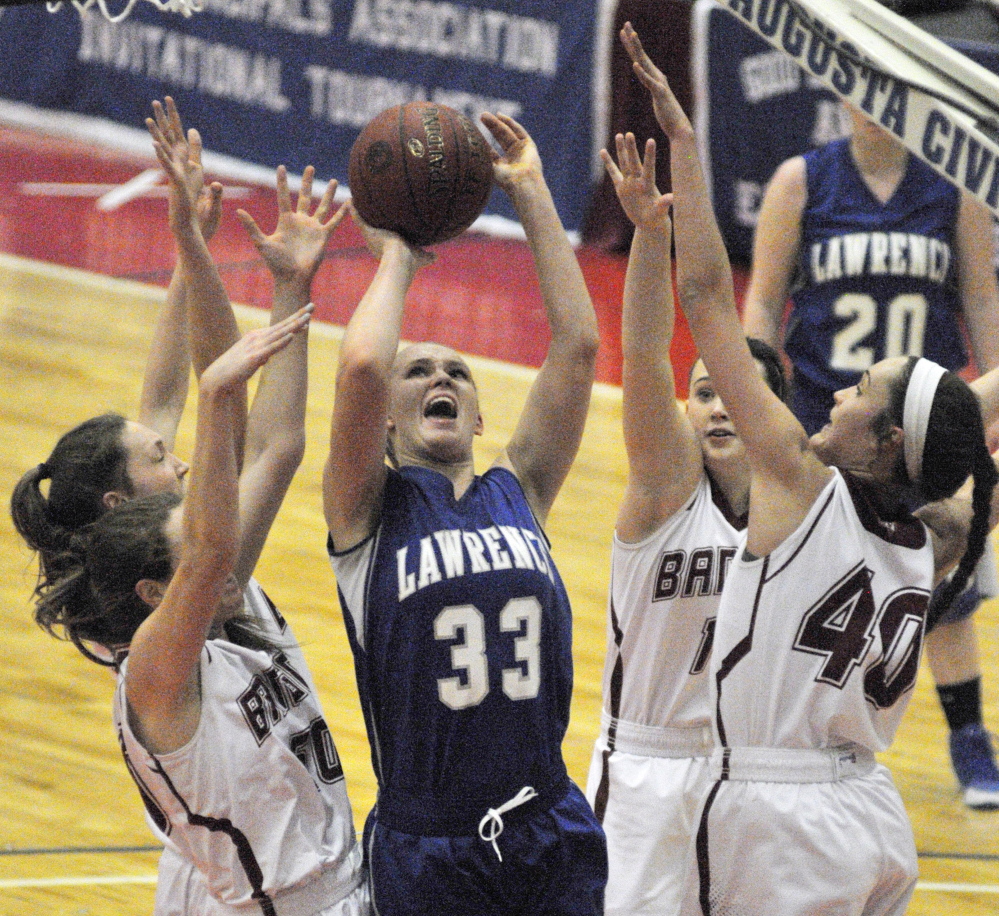 Lawrence junior center Nia Irving takes a shot on Bangor during the Eastern A final last Saturday at the Augusta Civic Center. Irving and the Bulldogs will play Thornton Academy on Saturday in the Class A state title game.