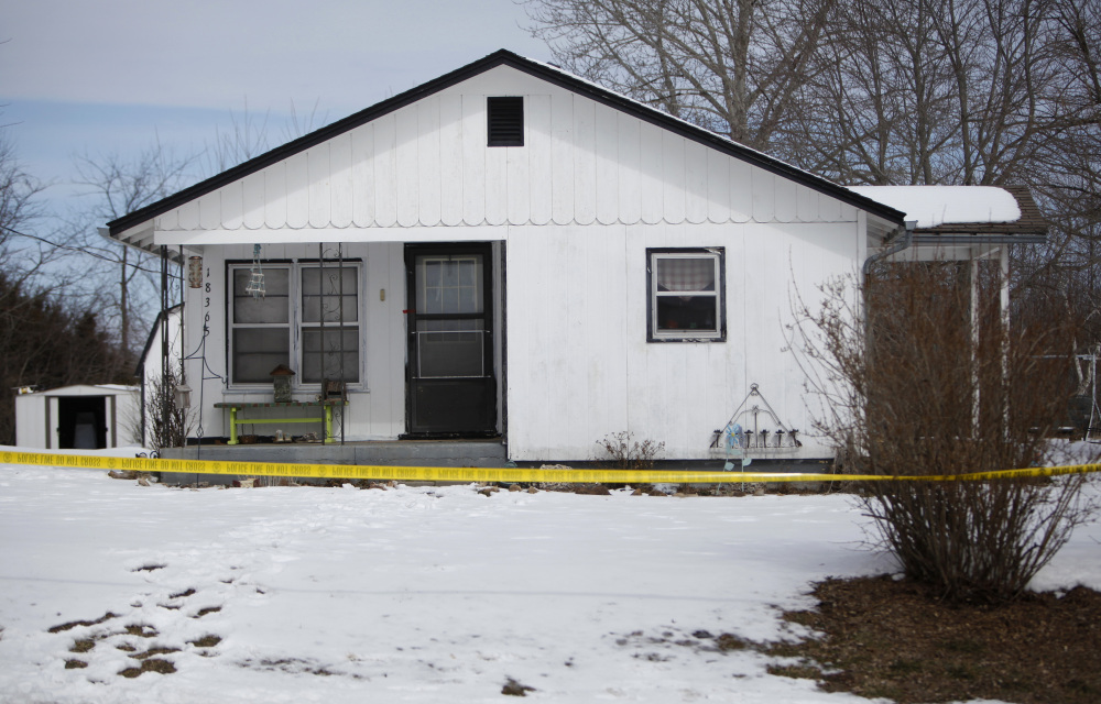 Police tape surrounds one of five crime scenes near Tyrone, Mo., on Friday morning.