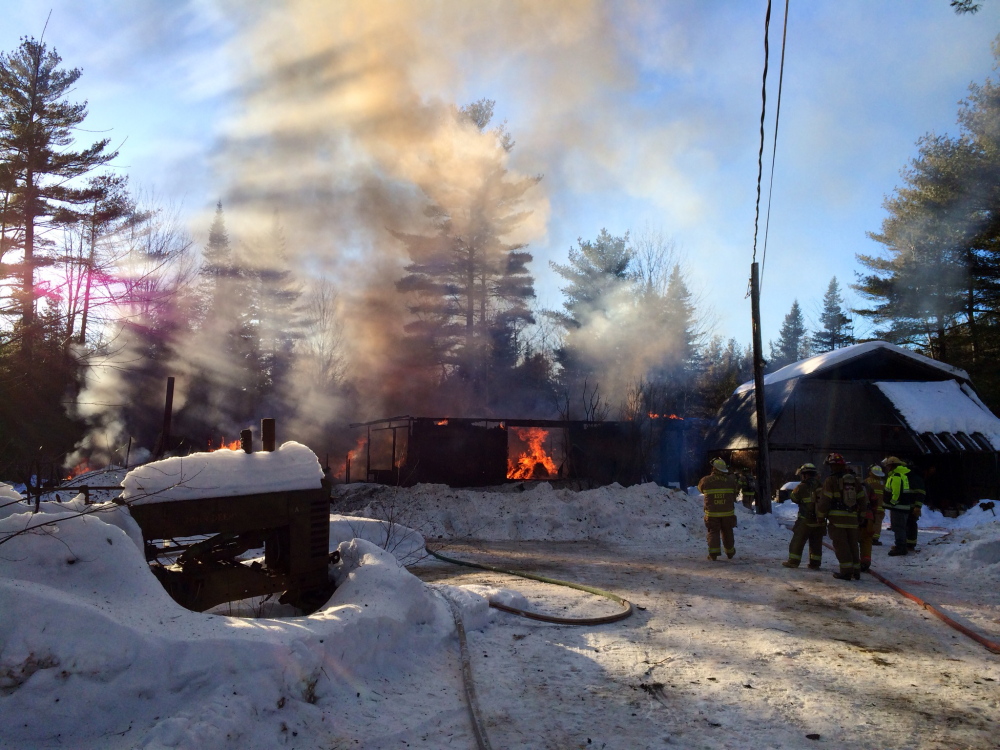 Firefighters battle a blaze Saturday that eventually destroyed a home at 564 Canaan Road in Clinton.