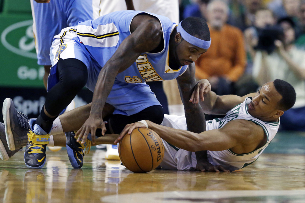 Celtics guard Avery Bradley gains control of the ball during a scramble with Denver Nuggets guard Ty Lawson in the second half of Wednesday night’s game in Boston. The Celtics won, 104-100.
